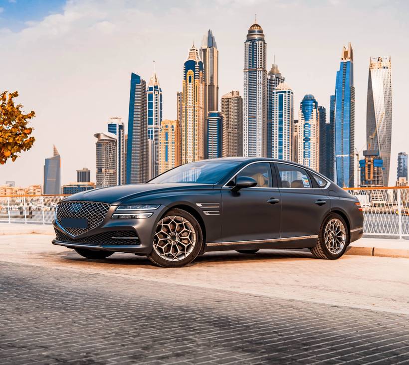 luxury sedan car in front of buildings.jpg