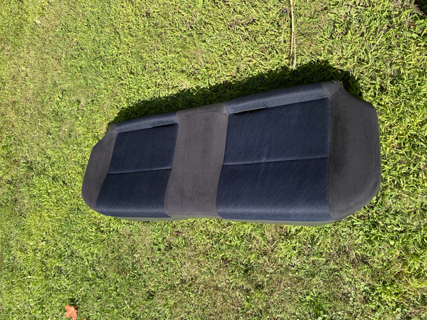 Steam cleaned rear bench seat bottom from 2003 Subaru WRX wagon drying outdoors on grass