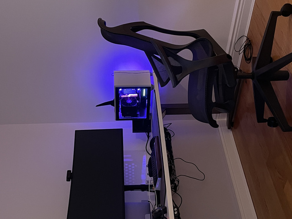 Herman Miller Cosm chair in front of nest with Cooler Master NR200P and ultrawide monitor