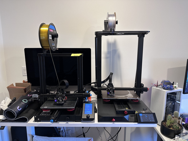 Creality 3D printers on a desk printing at the same time