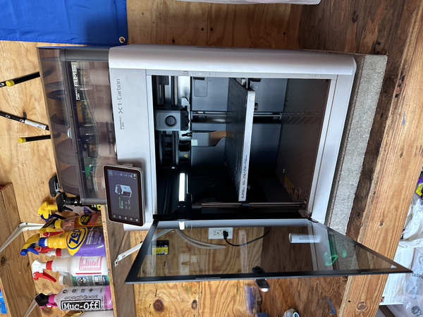 Front view of a Bambu Lab X1-Carbon with the glass door open