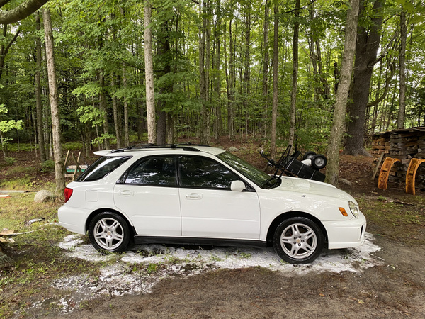 Cleaned up white 2003 Subaru WRX Wagon from the side