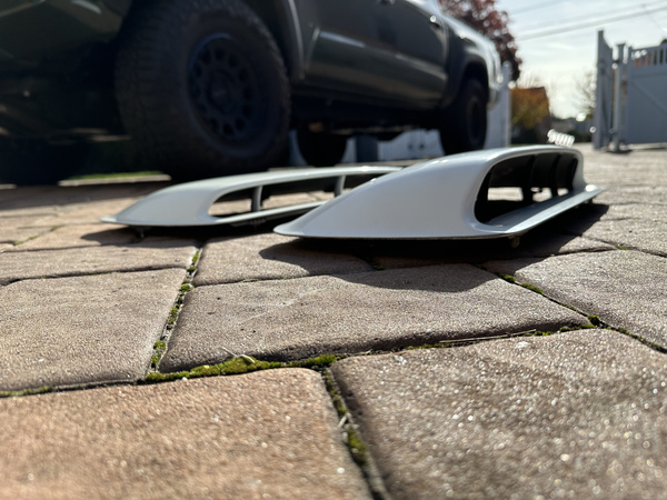 USDM WRX hoodscoop next to Model Year 2002/3 JDM STi Hoodscoop