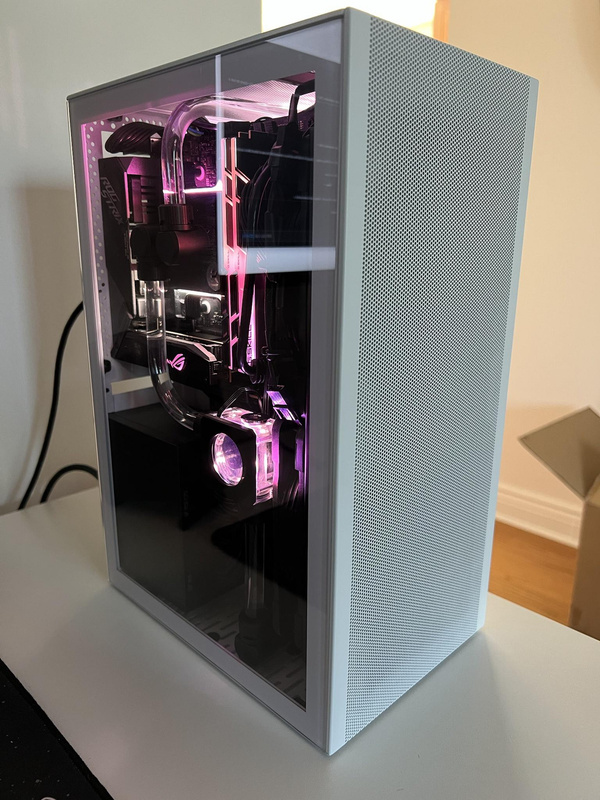Custom water loop in Ssupd Meshlicious case with pink lighting sitting on a desk