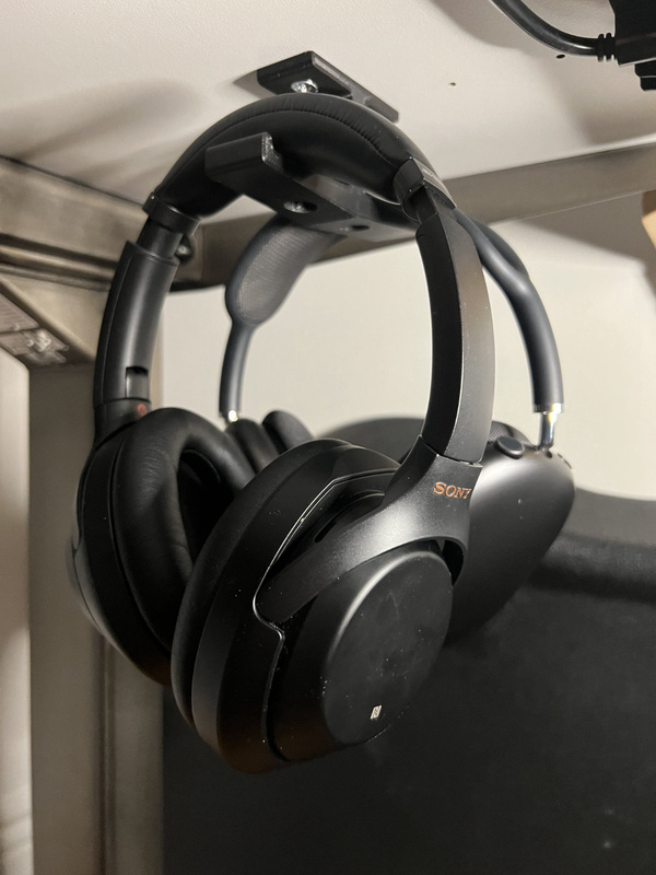 Headphones hanging on a 3D printed headphone hook