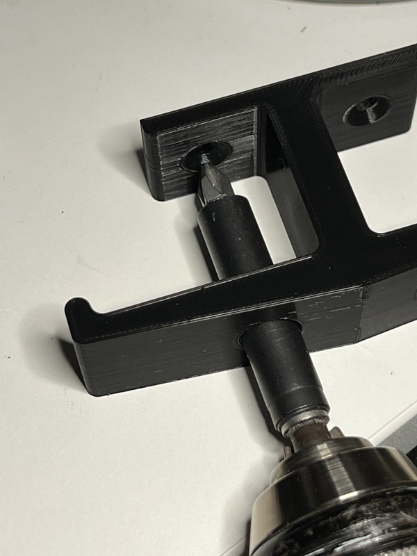 3D printed headphone hook with drill bit extension showing clearance of new design