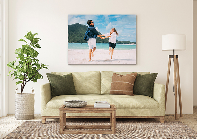 couple dancing on a beach canvas print over a sofa in a living room