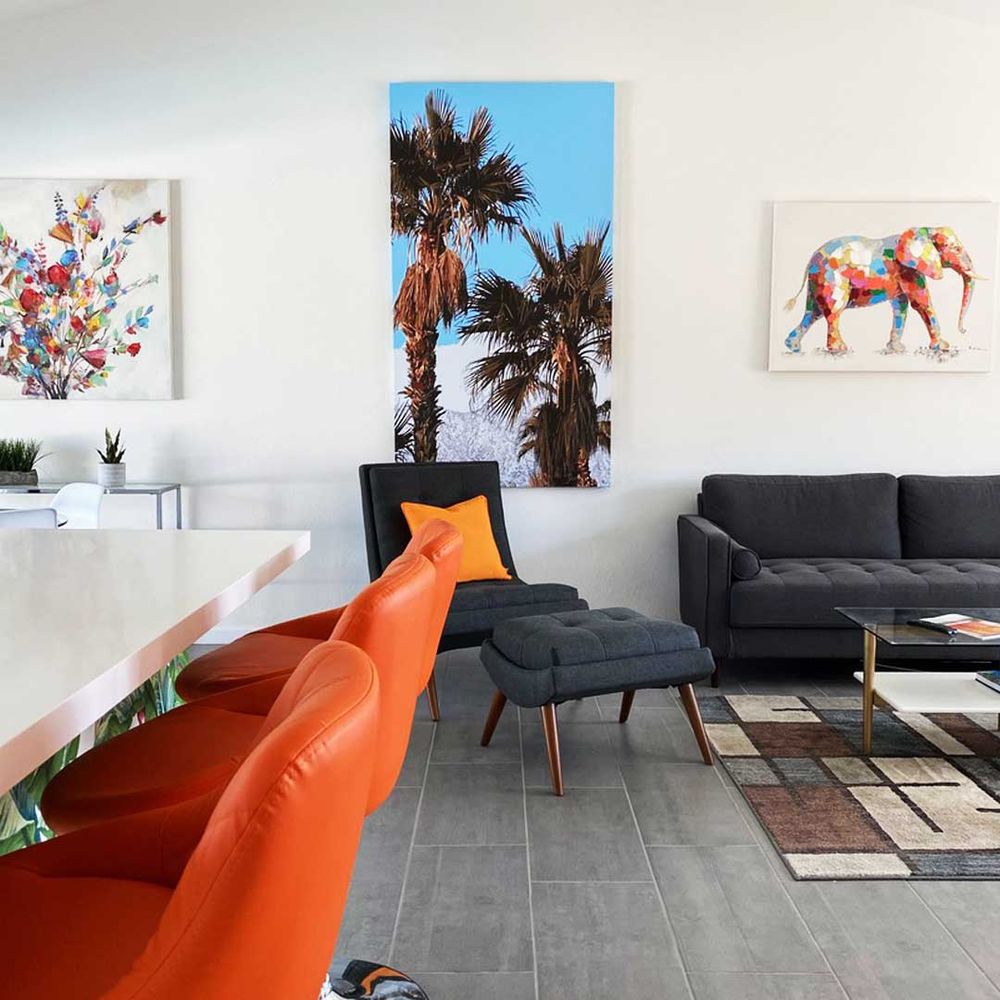 Three canvas prints on a living room wall