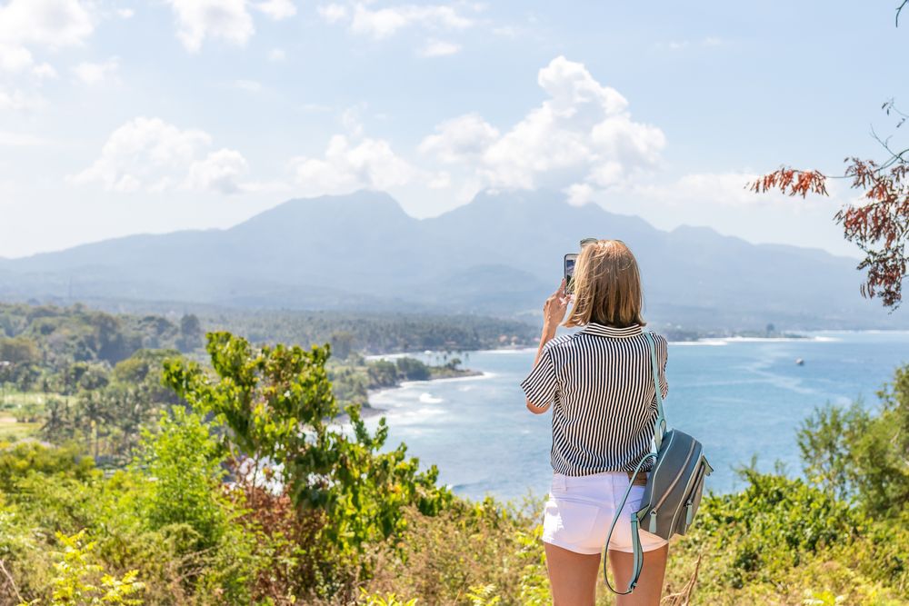 Woman taking a photo of the landscape