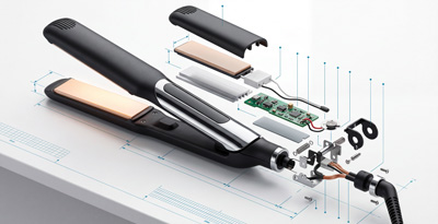 Fully disassembled hair straightener showing housing, heating plates, and electronic components catalogued for a teardown and benchmarking cost study 