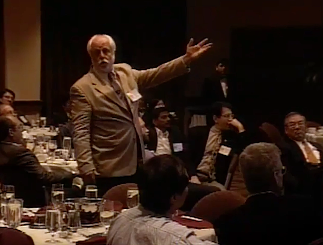 A. Neil Pappalardo standing in front of a blackboard.
