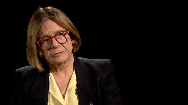 Sheila E. Widnall seated in front of a black background for an on camera interview.
