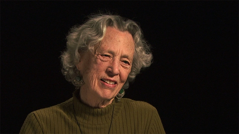 Emily V. Wade seated in front of a black background for an on camera interview.