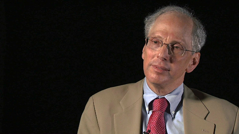 Jeffrey Shapiroseated in front of a black background for an on camera interview.