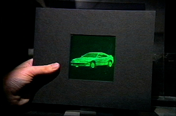 A bright green holographic image of a car.