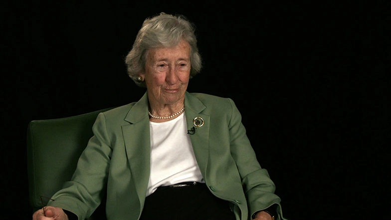Mary Frances Wagley seated in front of a black background for an on camera interview.