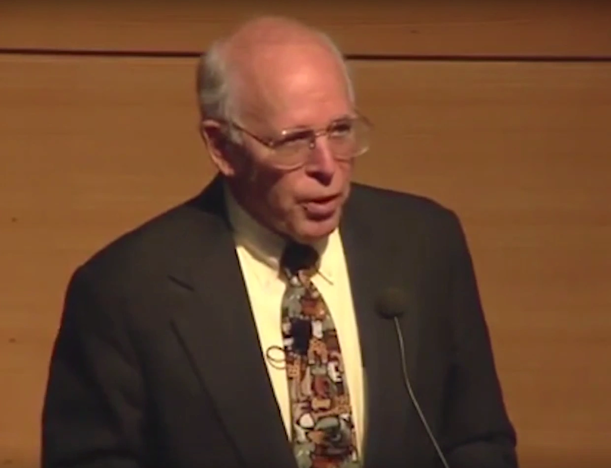 John Gibbons speaking in front of microphone