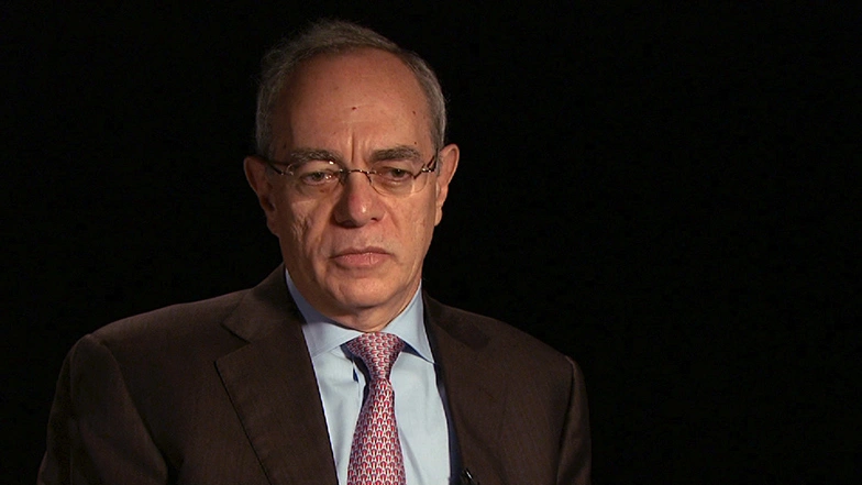 L. Rafael Reif seated in front of a black background for an on camera interview.