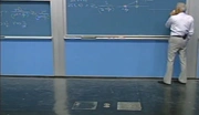 Amar Bose writing on large blackboard