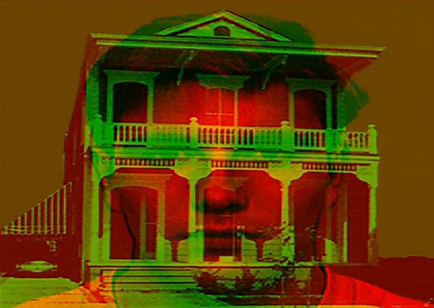 Man's face in red light with a two story New England style home superimposed over it in green light.