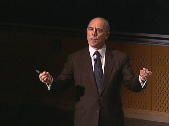Rafael Bras giving lecture in classroom, chalkboard in background