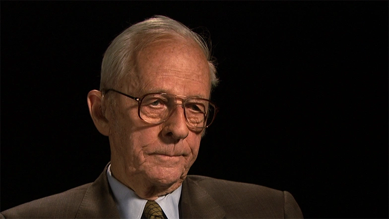 Jay Forrester seated in front of a black background for an on camera interview.