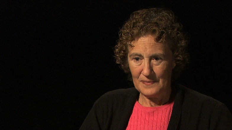  Barbara Liskov seated in front of a black background for an on camera interview.