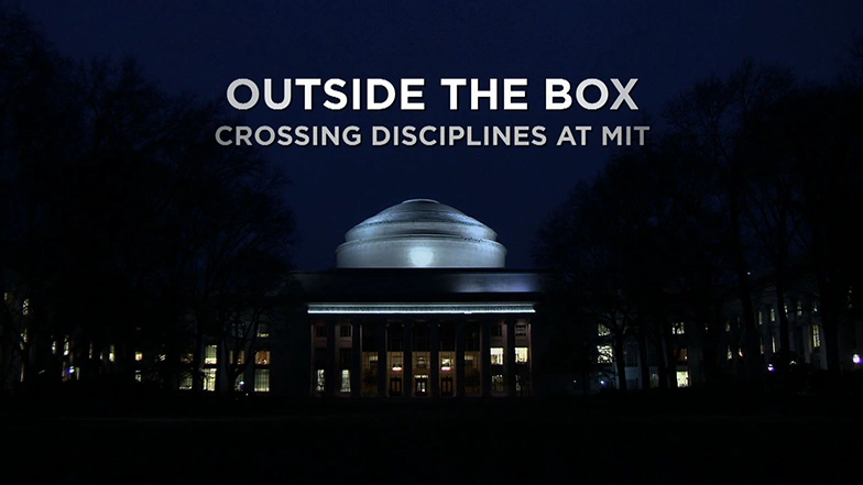 MIT Building at night with the Great Dome in the center, a few windows lit.