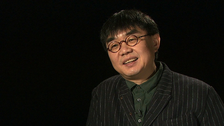 Yung Ho Chang seated in front of a black background for an on camera interview.