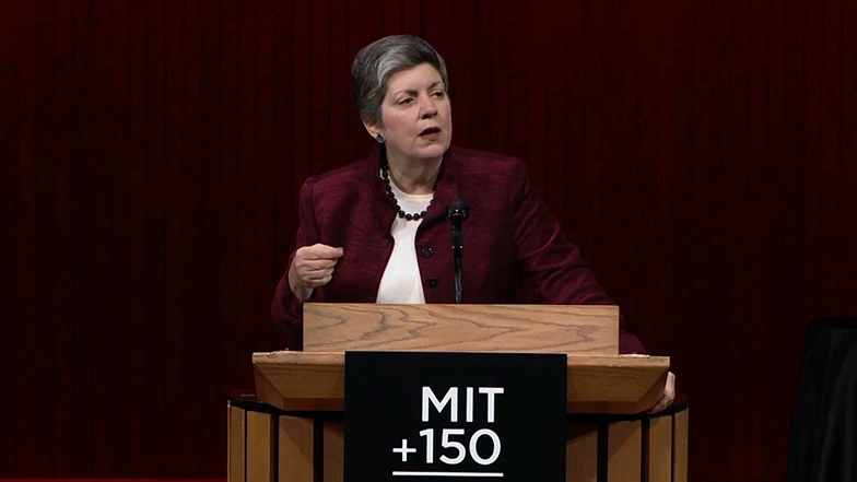 Janet Napolitano delivers a lecture at a podium onstage