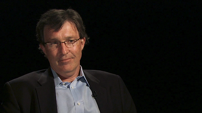 Tyler Jacks seated in front of a black background for an on camera interview.
