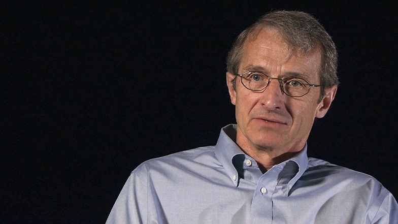 Richard R. Schrock seated in front of a black background for an on camera interview.
