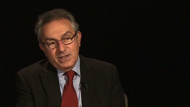 James A. Champy seated in front of a black background for an on camera interview.