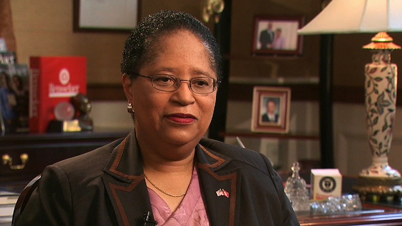 Shirley A. Jackson seated in a well decorated office, looking ahead during an on camera interview.