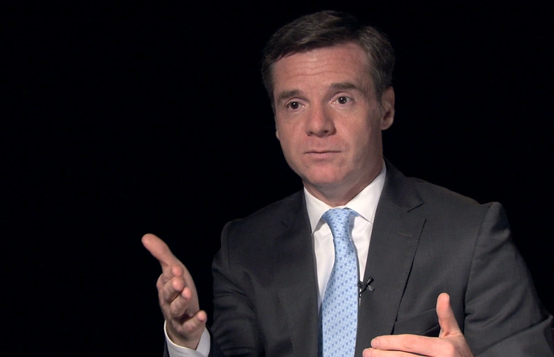 Israel Ruiz seated in front of a black background for an on camera interview.