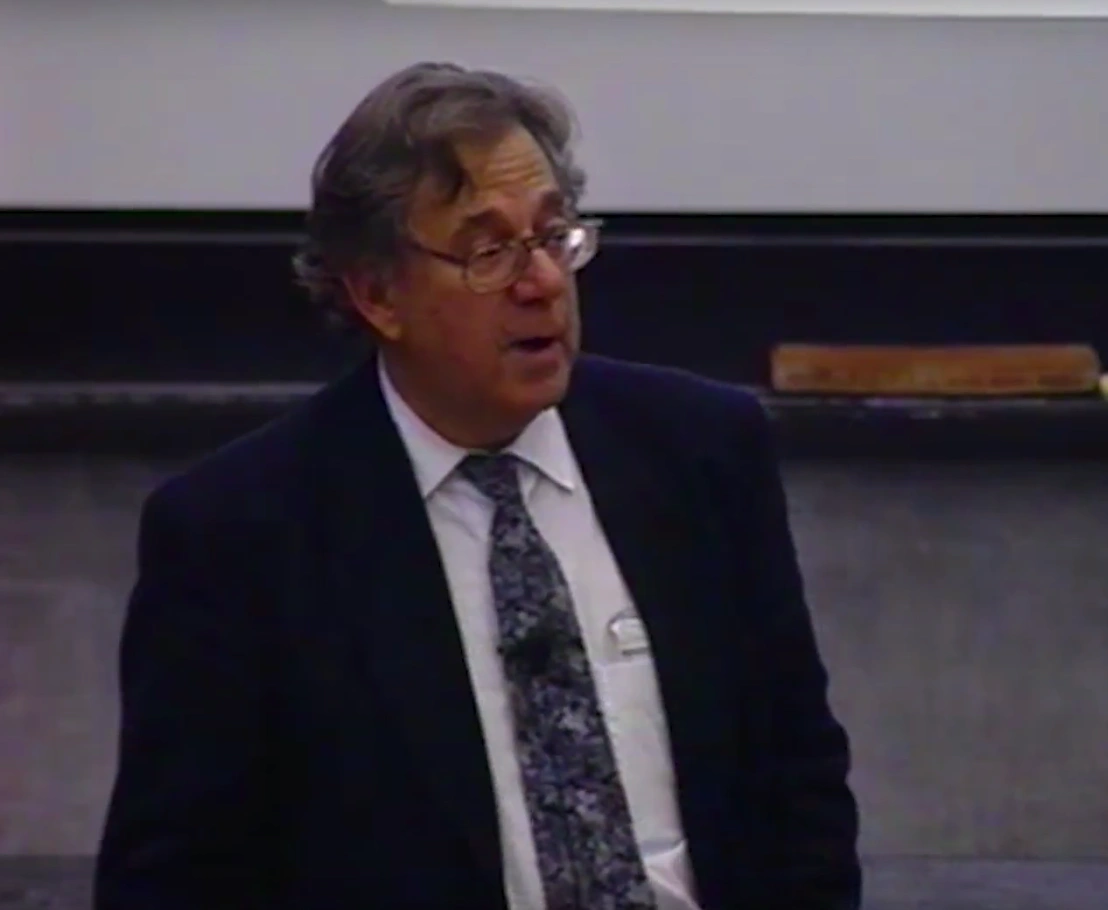Paul Joe Crutzen lecturing in a classroom, standing in front of a chalkboard .