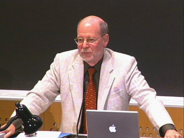 H. Robert Horvitz speaking at podium in classroom, with a chalkboard in the background.