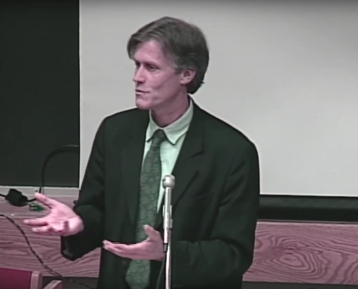 Karl Henrik Robèrt speaking behind a podium in a classroom