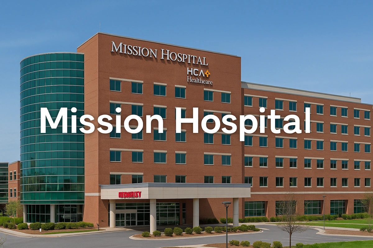 Exterior view of Mission Hospital in Asheville, NC, a modern brick and glass medical center with the text overlay 'Mission Hospital' across the building façade.